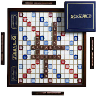 Scrabble Deluxe Edition board with a few played words on it.